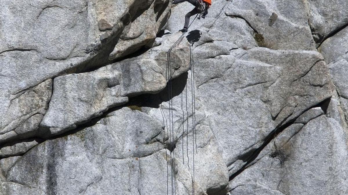 This photo taken March 5, 2012, shows rock climbers enjoying the warm temperatures as they climb the granite walls at the mouth of Little Cottonwood Canyon, Utah.