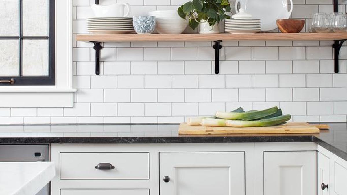 Fresh green plants are a simple way to add color to a monochrome kitchen.