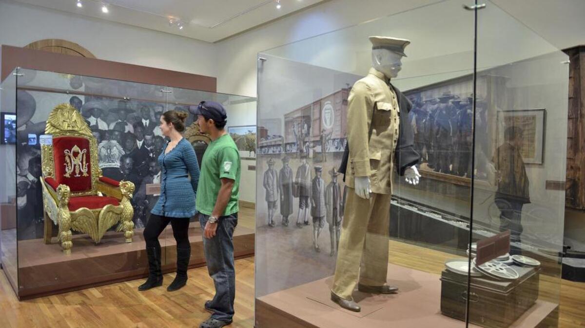 This undated photo provided by the Mexico Tourism Board and Fideicomiso ¡Ah-Chihuahua! shows visitors looking at a chair on display at the Museum of the Revolution in the Border in Ciudad Juarez, Mexico. The museum tells the story of the revolution, a turbulent chapter of history that lasted from 1910 to 1920 and transformed Mexican society. The chair is part of an exhibit showing where revolutionary leaders Pancho Villa and Emiliano Zapata sat at the National Palace after attacks on Mexico City.