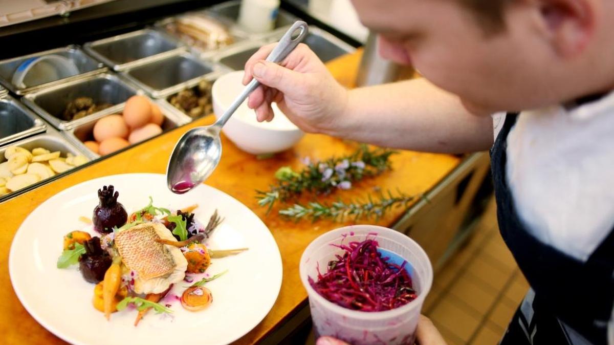 Chef Brendan Cox styles a North Carolina Vermillion snapper with vegetables from the winter garden, pickled shallots and rosemary at Oakleaf in Pittsboro.
