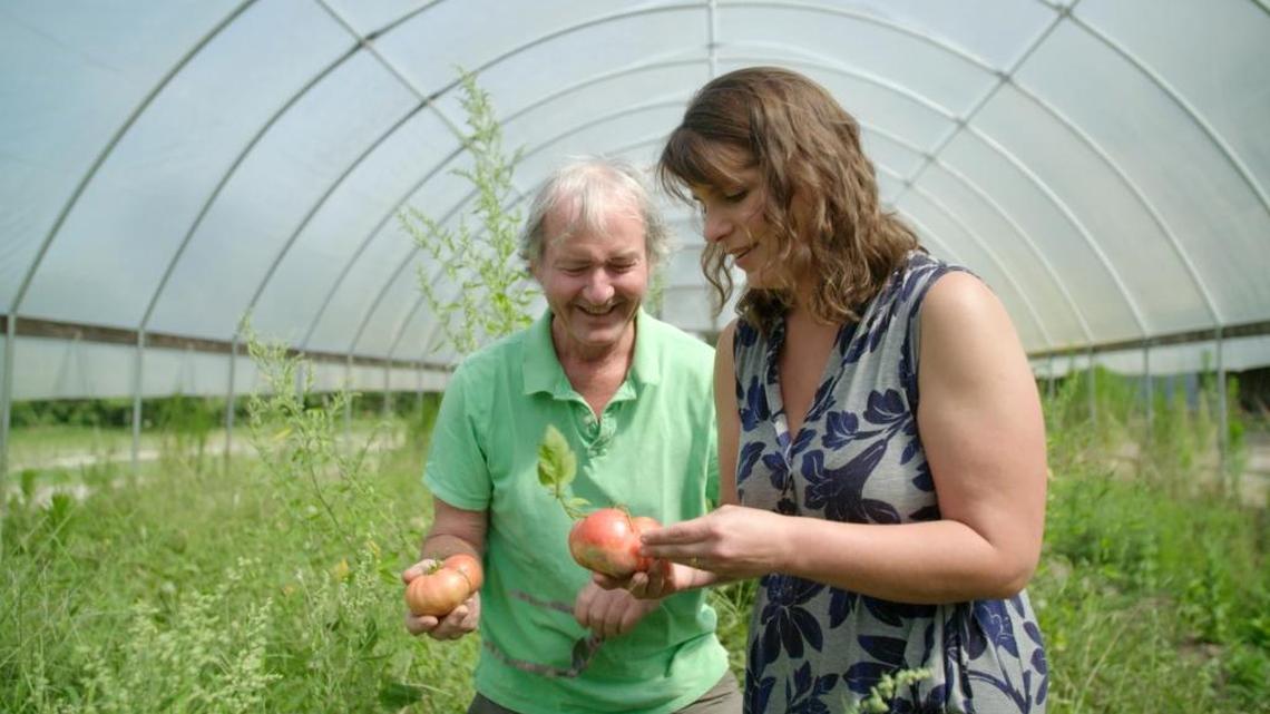 Kinston area farmer Warren Brothers, left, and Vivian Howard search for tomatoes in a still taken from the fifth season premiere of “A Chef’s Life.”