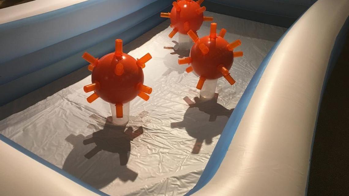 J.P. Trostle’s “The Best Healthcare in the World” is a baby pool in which three plastic bombs with detonators of empty pill boxes seemingly float.