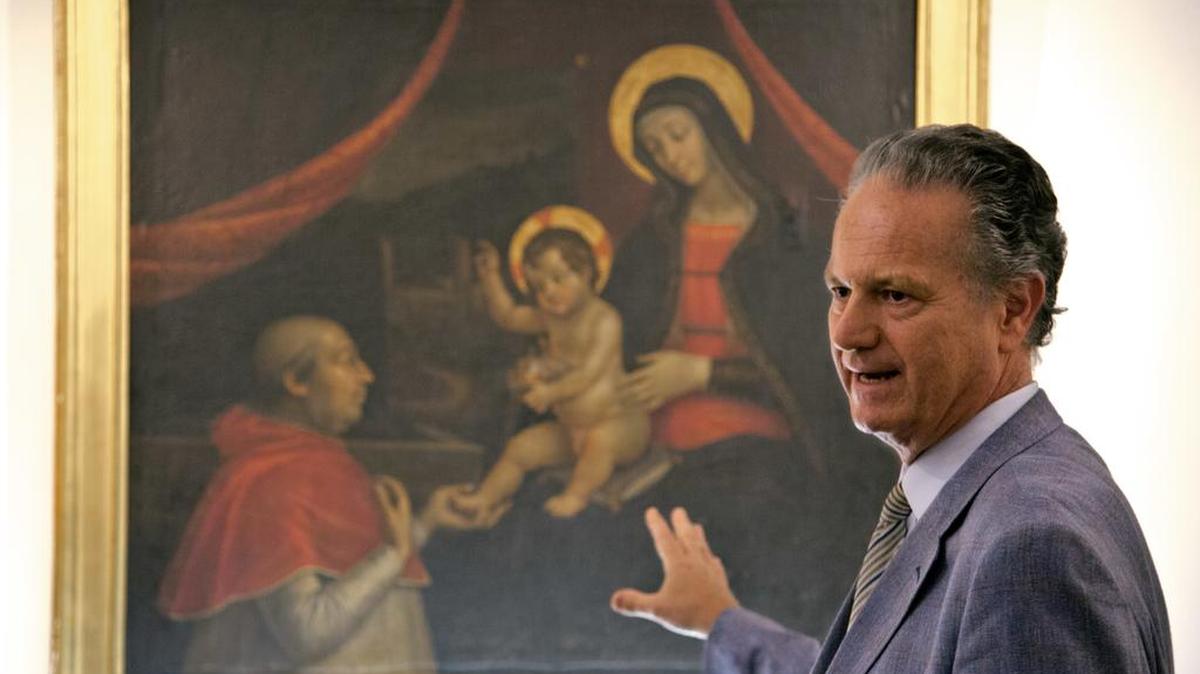 Former director of the Vatican Museums Francesco Buranelli speaks in front of a copy by Pietro Facchetti of Renaissance master Pintoricchio’s mural depicting Borgia Pope Alexander VI on his knees before Baby Jesus held by the Virgin Mary that once decorated a private chamber in the Borgia papal apartment at the Vatican.