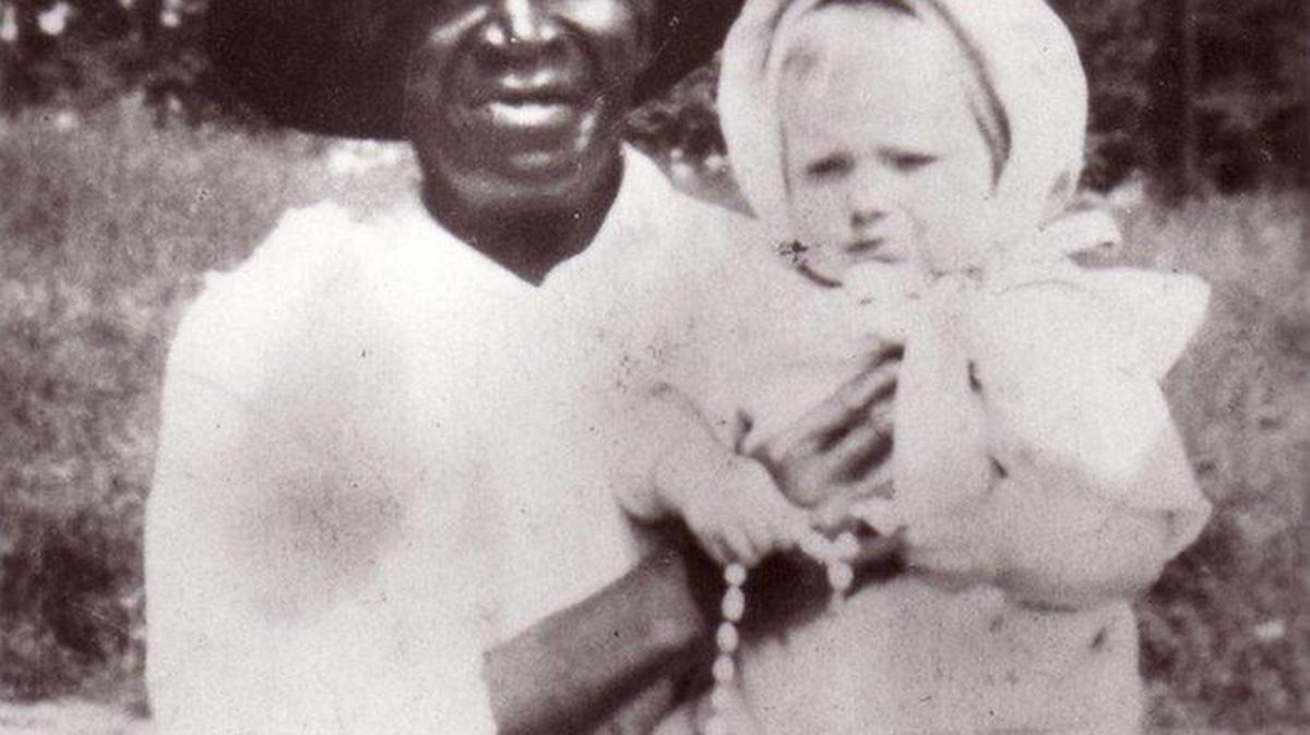 This 1916 photo provided by the Archdiocese of Denver shows Julia Greeley with Marjorie Ann Urquhart in McDonough Park in Denver. Greeley, a former slave, is being considered for possible sainthood. In a step toward possible sainthood, the remains of Greeley were moved to a Catholic cathedral in Denver. People lined up Wednesday, June 7 to honor her and pray for her help at the cathedral.