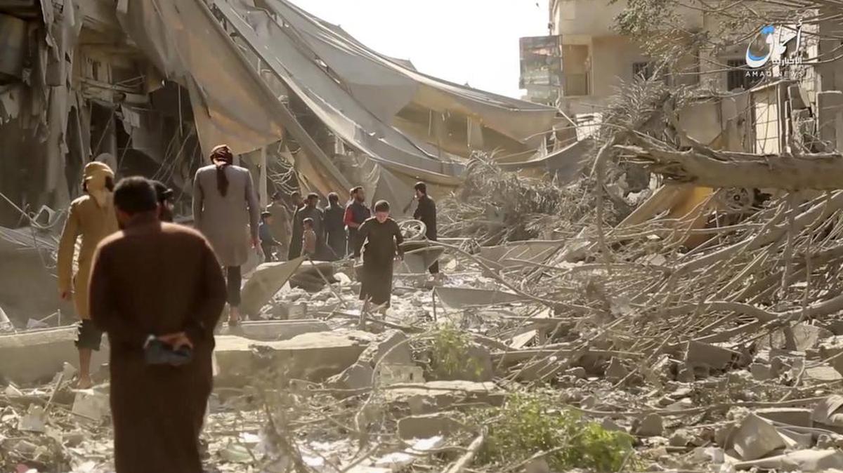 This undated frame grab from video posted online Monday, May 29 by the Aamaq News Agency, a media arm of the Islamic State group, shows people inspecting damage from airstrikes and artillery shelling in the northern Syrian city of Raqqa, the de facto capital of the IS. Airstrikes have intensified over the past days as U.S.-backed fighters have marched toward the city, getting closer to besieging it from all sides.