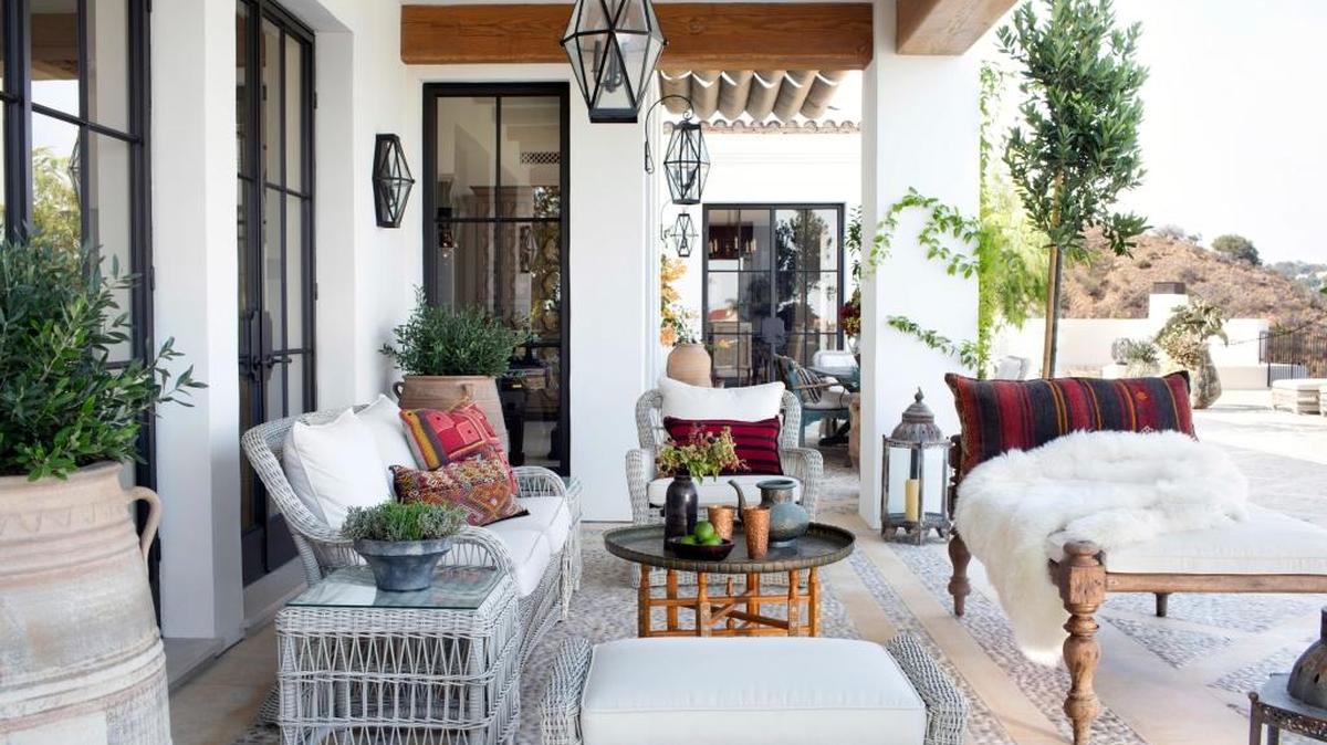 This undated photo provided by Betsy Burnham shows a patio area in Los Angeles designed by Burnham of Burnham Design. Rather than selecting a set of matching outdoor furnishings, designers are encouraging clients to mix and match a variety of styles and brands as they decorate their outdoor space.