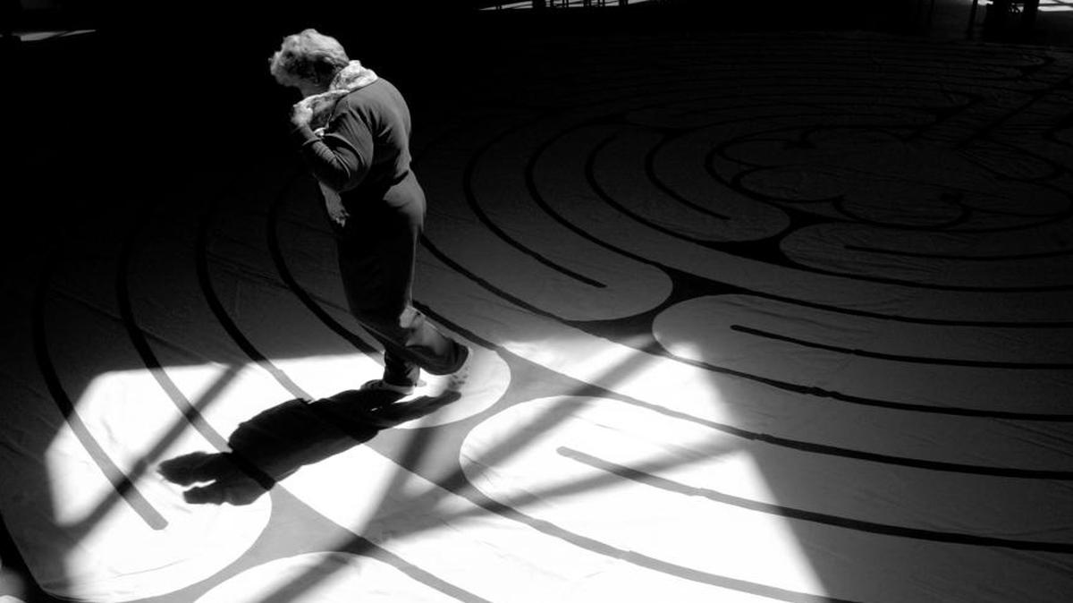 Stepheny Houghtlin walks the labyrinth in the sanctuary of The Olin T. Binkley Memorial Baptist Church in this file photo. “It’s a very special experience,” Houghtlin said of her walk. “It’s an opportunity to have a different experience of prayer.” The labyrinth, sponsored by a number of churches in the Chapel Hill area, is set up during Holy Week.