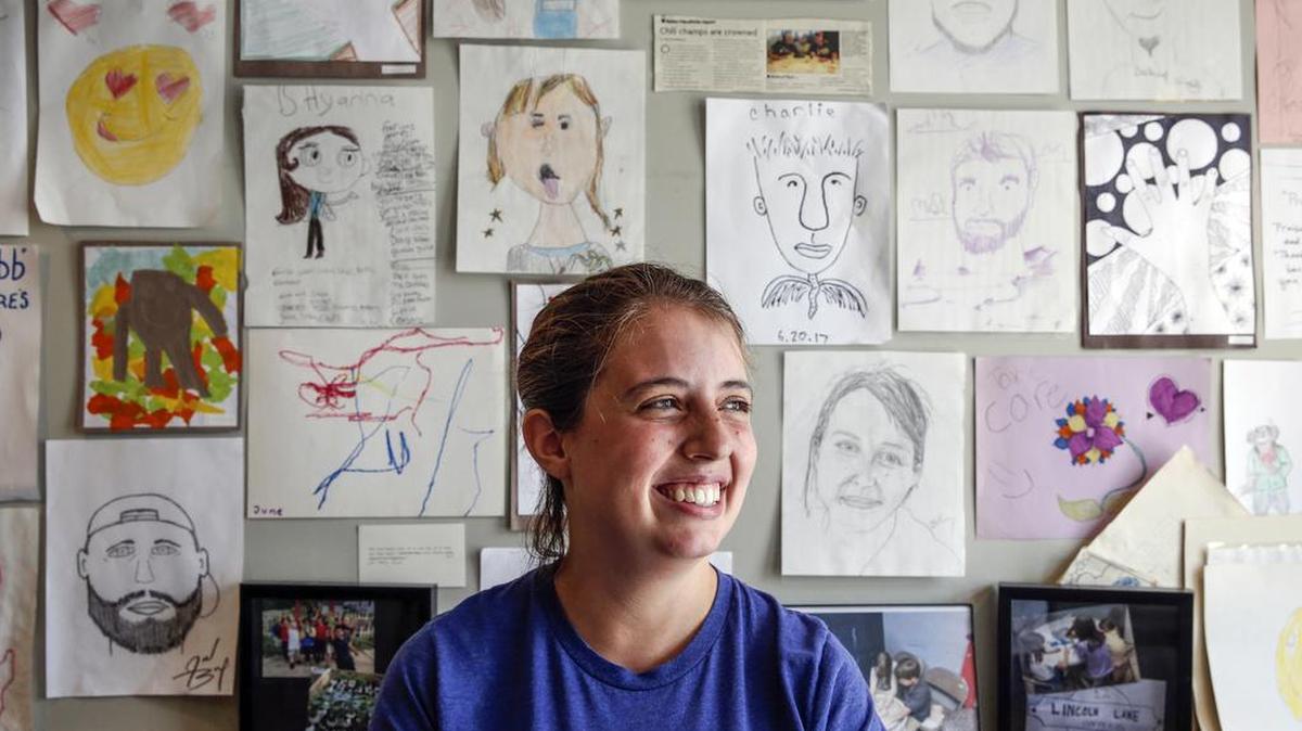Bethany Friesen, assistant director of The Lincoln Center, poses for a portrait in front of various self portraits drawn by students in the Center’s after school program and other community members on Monday, July 31. The Lincoln Center located in the Bates-Hendricks neighborhood, an area that is seeing lots of redevelopment but few community spaces for low-income residents.