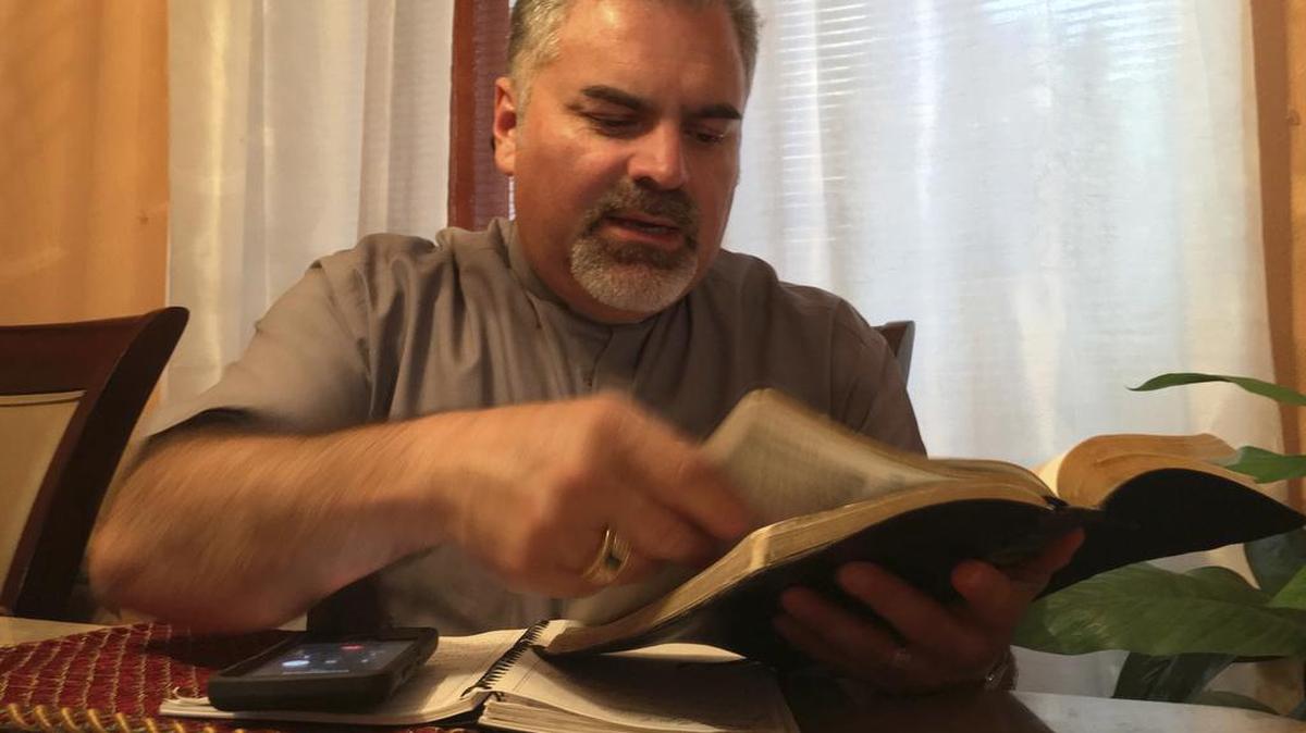 Pastor Julio Barquero, a lay minister in the Disciples of Christ, holds a conference call bible study and prayer session with attendees to afraid to go to church in Houston. Many of the callers are undocumented immigrants.