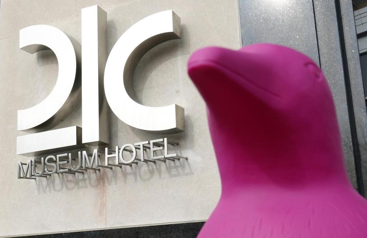There are 25 four foot tall fuchsia artwork penguins, right, spread outside and among several floors Monday morning, March 16, 2015 for the grand opening of the newest 21c Museum Hotel in the renovated ca. 1937 Hill Building at 111 North Corcoran Street, Durham. The newest 21c Museum Hotel in Durham, NC is the fourth in the nationwide hotel chain. It offers 10,500 square feet of art exhibition space and a 125 room boutique hotel and restaurant open to the public.