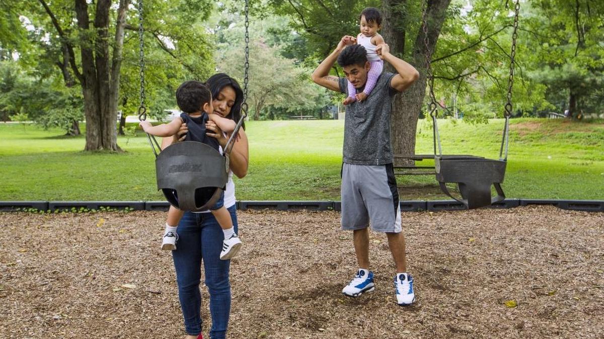 Erika Ventura, left, lifts her son, James Ventura, out of a swing at Northgate Park as her husband Jonathan Ventura holds their daughter, Eva, on Wednesday Aug. 16, 2017, in Durham, NC. Erika and James have been coming to this park since they were kids themselves. “Now we have our children here who would’ve thought,” Erika said, having moved to the Northgate Park neighborhood seven years ago.