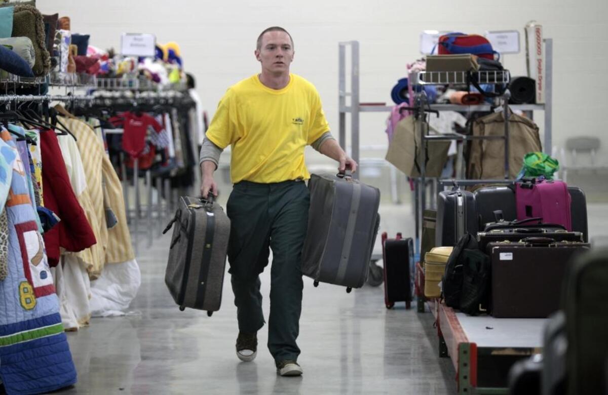 Richard Matthews hustles donated luggage to another display to make room for more donated in this file photo from Nov. 6, 2014. The nonprofit substance-use treatment center was preparing to open its new TROSA Thrift Store at Durham’s Oxford Commons Shopping Center on Nov. 7, 2014. The store has 65,000 square feet of sales space for the public.