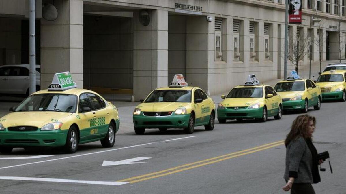 Amigo Taxis circle the Wake County Justice Center in downtown Raleigh in this file photo from February 2016. Cab owners in North Carolina must carry higher liability insurance starting Oct. 1 under a bill passed this summer.