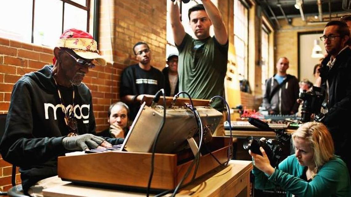 Musician Bernie Worrell, far left, is surrounded by photographers while he plays in the Pop-up Factory at the Boiler Room Lobby during Moogfest in Durham on Friday, May 20, 2016. Worrell is a founding member of Parliament/Funkadelic.