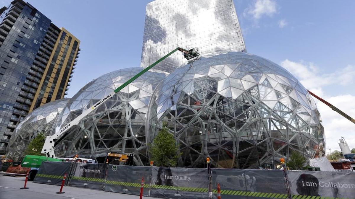 The April 27 file photo shows underway on on three large, glass-covered domes at the Amazon campus in downtown Seattle. Amazon said earlier this month that it will spend more than $5 billion to build another headquarters in North America to house as many as 50,000 employees. The two bidding cities in North Carolina are Charlotte and Raleigh.