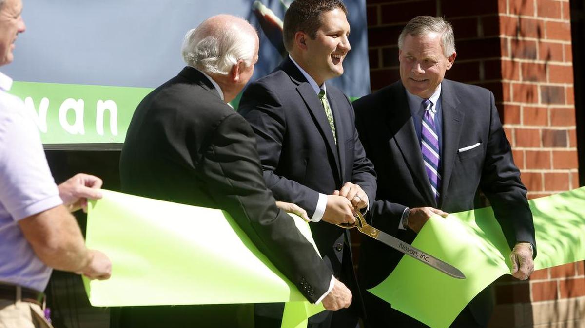 Former U.S. Sen. Richard Burr, R-N.C., right, is pictured with former Novan CEO Nathan Stasko and chairman Robert Ingram during the ribbon cutting at Novan’s corporate headquarters in Research Triangle Park in 2016.