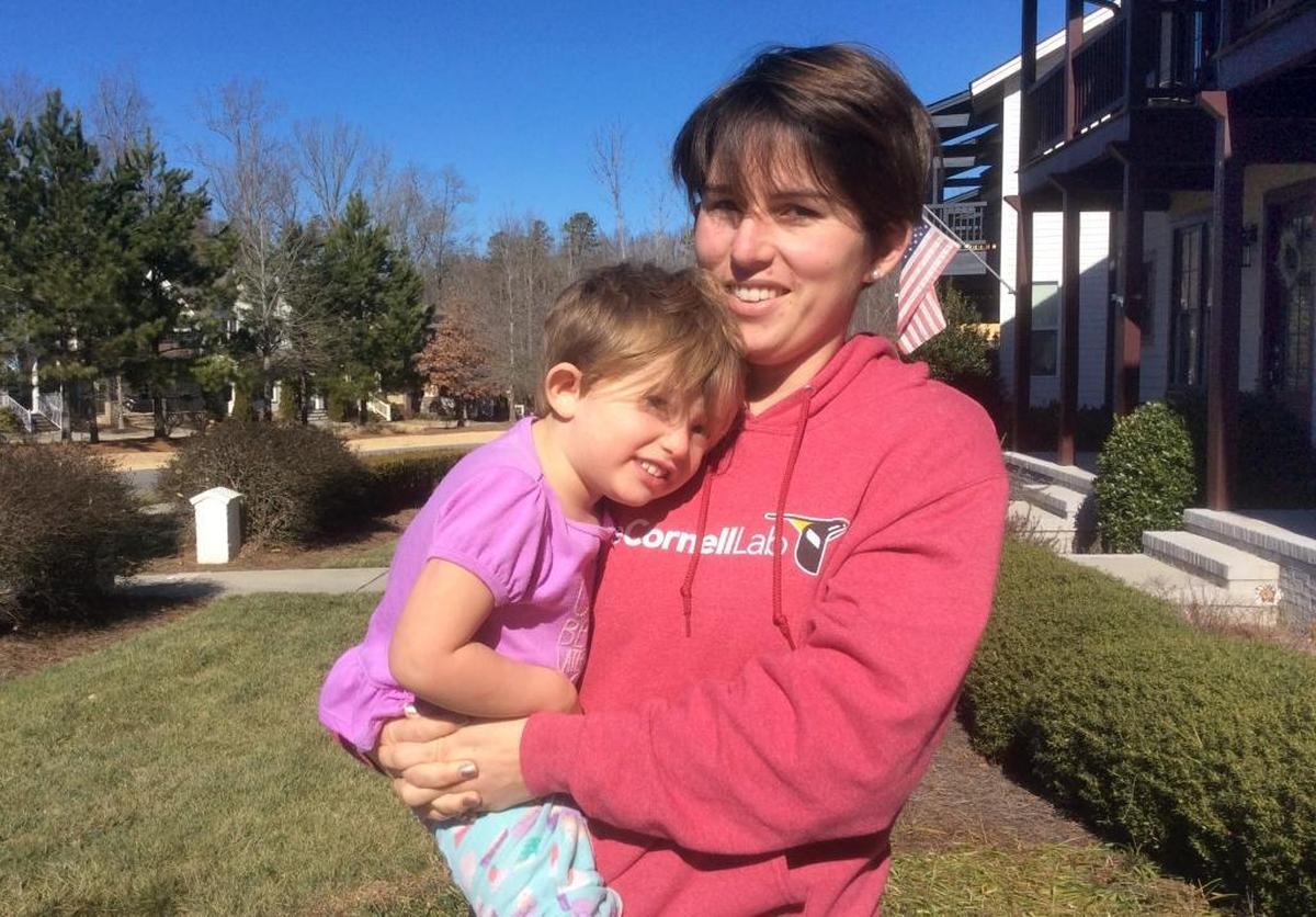 Jessica Walden-Gray holds her daughter outside their family’s Great Ridge Parkway townhouse in the Briar Chapel community in Chatham County. Walden-Gray and other residents are fighting a 128 percent increase in their service fee to pay for landscaping of their small lawns and exterior work on the townhouses.