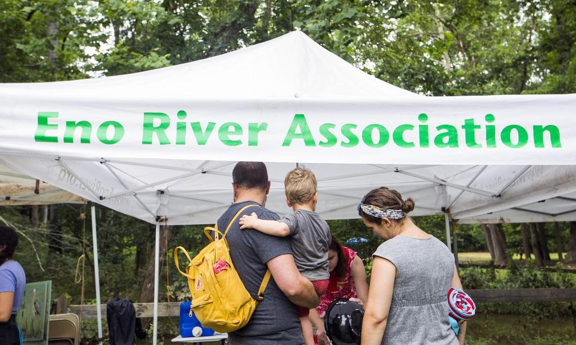 A family visits the Eno River Association tent during the Festival for the Eno on Saturday.