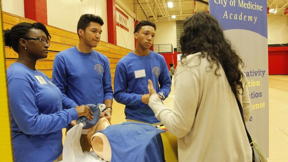 City of Medicine Academy students show off their work during a recent Magnet School Fair.