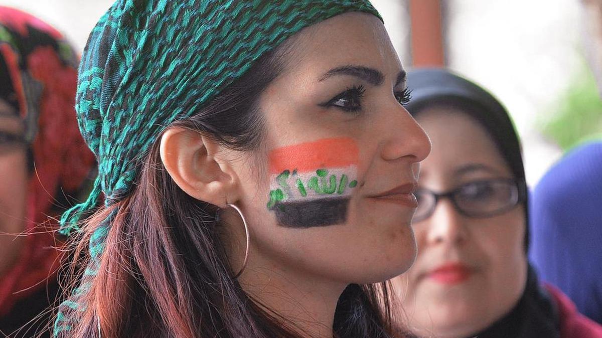 Iraqi Rasha Sherlock celebrates Durham Refugee Day with music, food, games and community education at Durham Central Park Saturday.