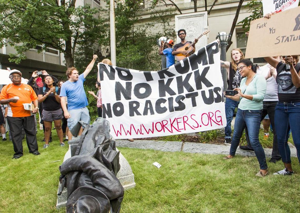 A group of protesters cheer after toppling Confederate soldier statue during an “Emergency Durham Protest” at the old Durham County Courthouse in response to the violent protests Saturday in Charlottesville, on Monday, Aug. 14, 2017, in Durham, NC. The group proceeded to march to the site of the new police headquarters under construction.