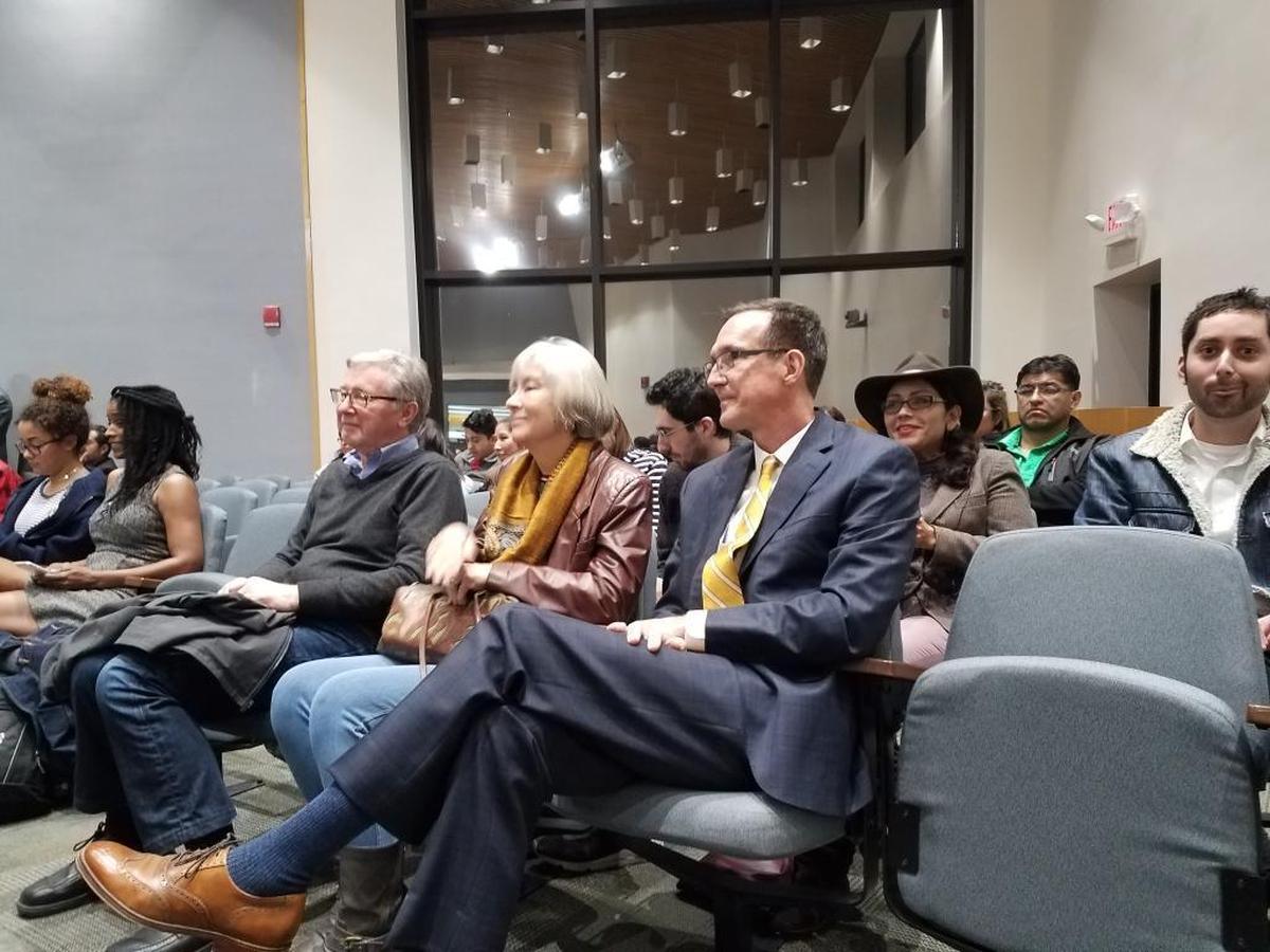 Carl Rist, in yellow tie, watches as a friend reads a statement from him withdrawing his name from consideration for the vacant Durham City Council seat during a special council meeting on Wednesdsay, Jan. 10, 2018.