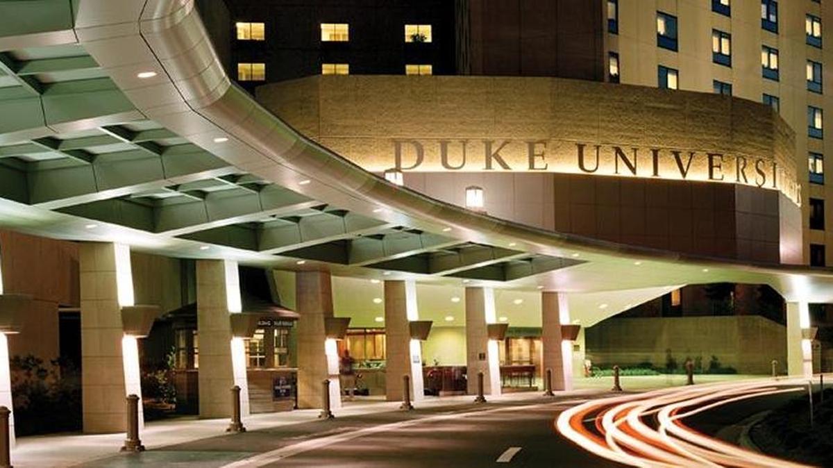 A man in police custody at Duke University Hospital was shot and killed by a Duke University police officer in the emergency department on Friday after he reached for a Durham police officer’s gun, hospital officials said.