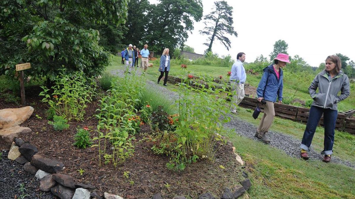 Hub Farm Project Manager Katherine Gill, right, leads a tour of the Durham Public Schools’ 30-acre farm Tuesday.