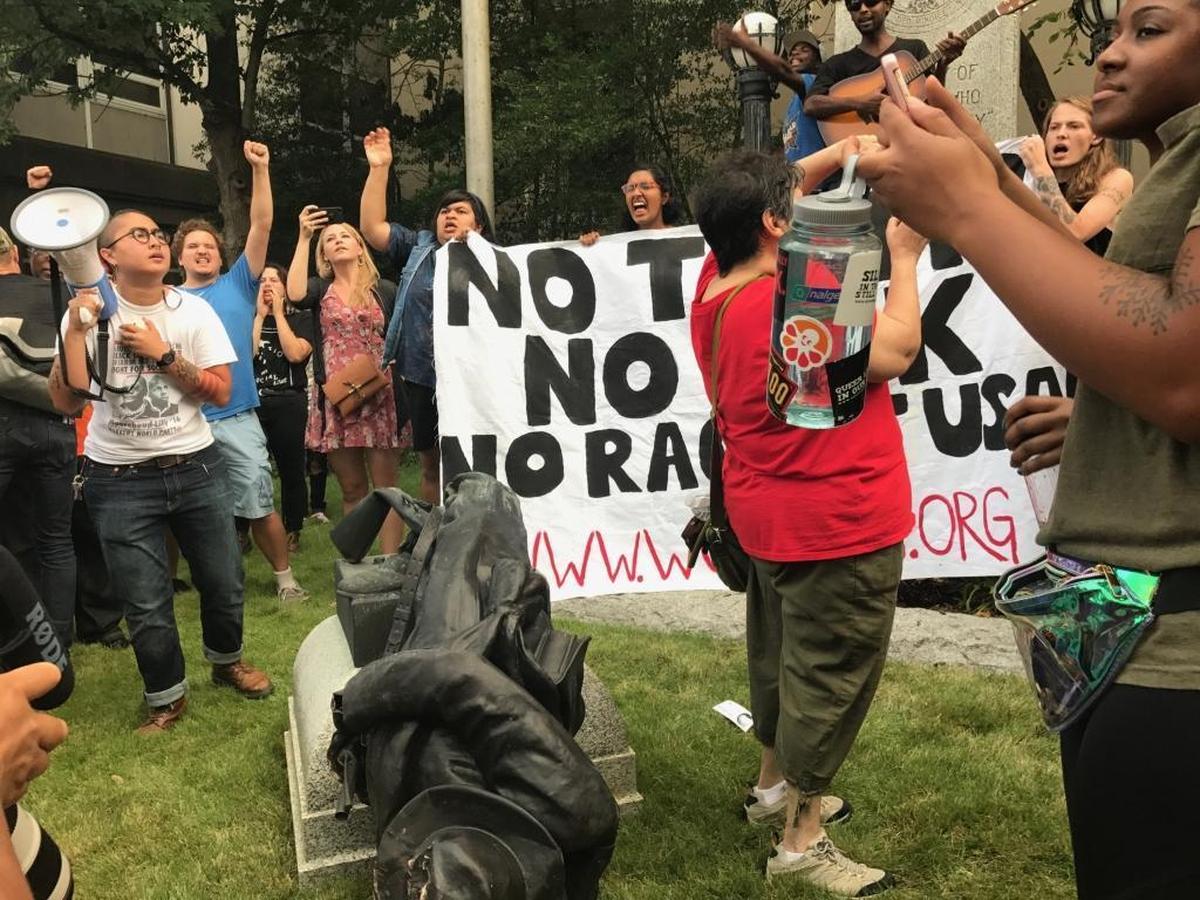 Protesters celebrate after pulling down a Confederate statue outside the old Durham County courthouse on East Main Street in Durham, Monday, Aug. 14, 2017.