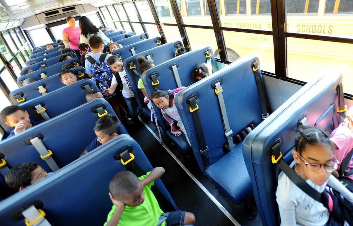Children ride a Durham Public Schools bus to Holt Elementary School in this 2016 file photo. The school is one of six elementary schools slated for comprehensive renovations if the 2022 education bond passes.