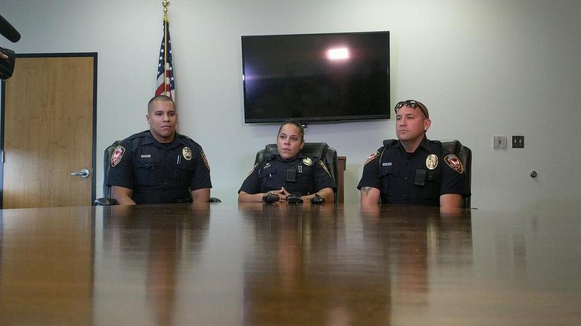 Durham police officers E.E. Ortiz, K. De La Cruz and A.M. Acker (from left) discuss their rescue of two women who were stranded in a sinking car in a pond off Alston Avenue Wednesday.