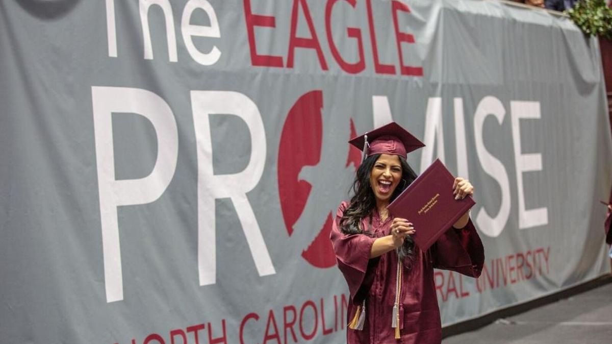 A happy graduate shows off her diploma during N.C. Central’s fall commencement on Saturday at McDougald-McLendon Arena.