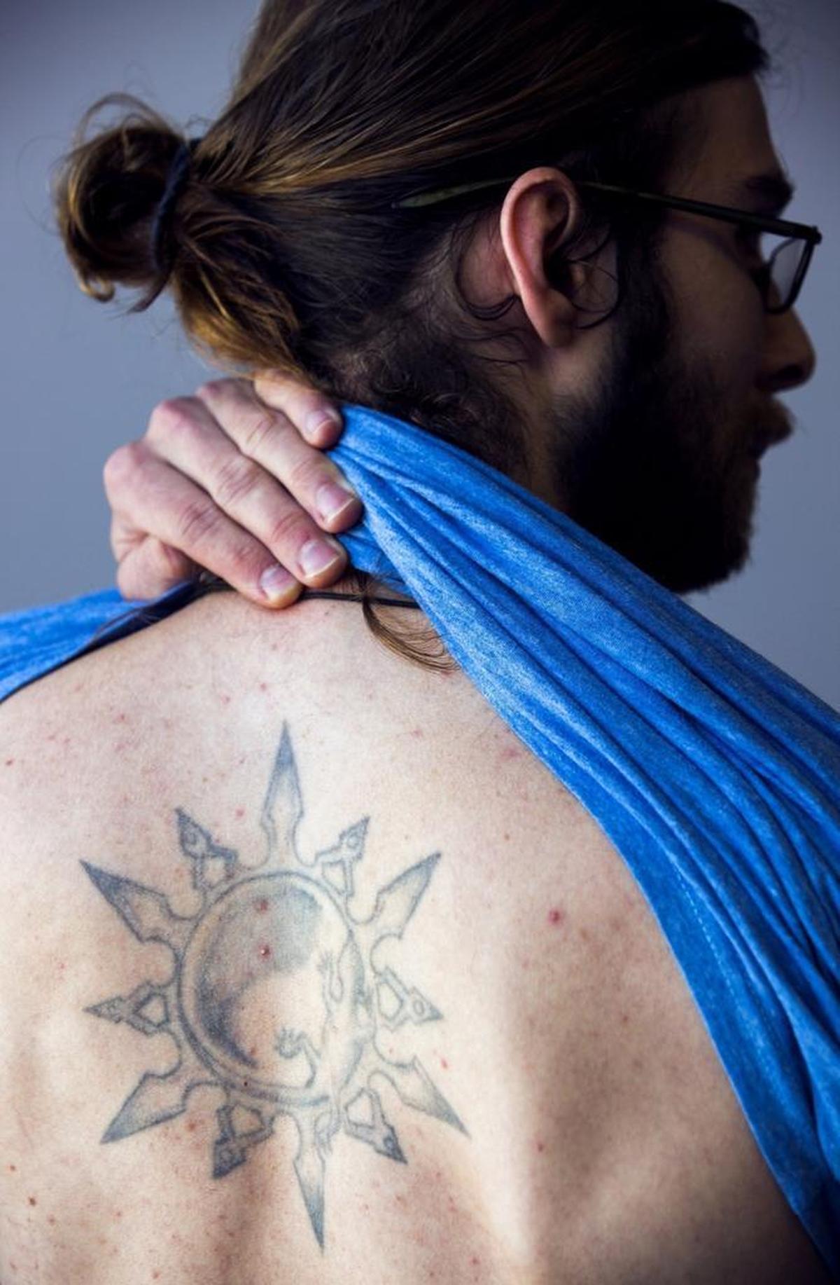 Soren Johnsen shows the tattoo that Samantha Castrovinci designed after only six months’ of experience during a consultation appointment after which Castrovinci planned to enhance the tattoo for free in Durham, NC.