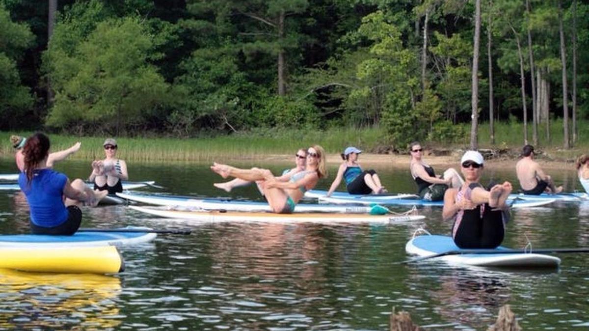 Maria Finnegan instructs a paddle boarding class at Jordan Lake. Durham Council members are evaluating updating its stormwater ordinance to be in compliance for nutrient standards required of developers related to the lake’s basin.
