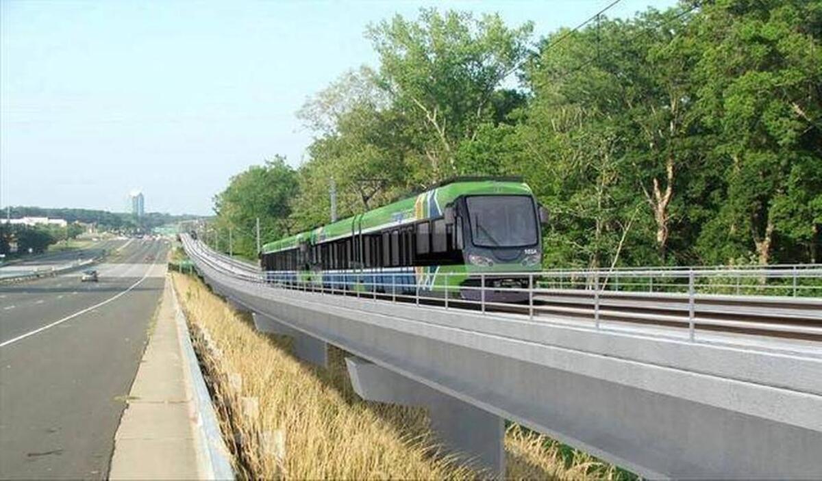 A concept illustration shows a train on the future Durham-Orange Light-Rail Transit traveling alongside U.S. 15-501.