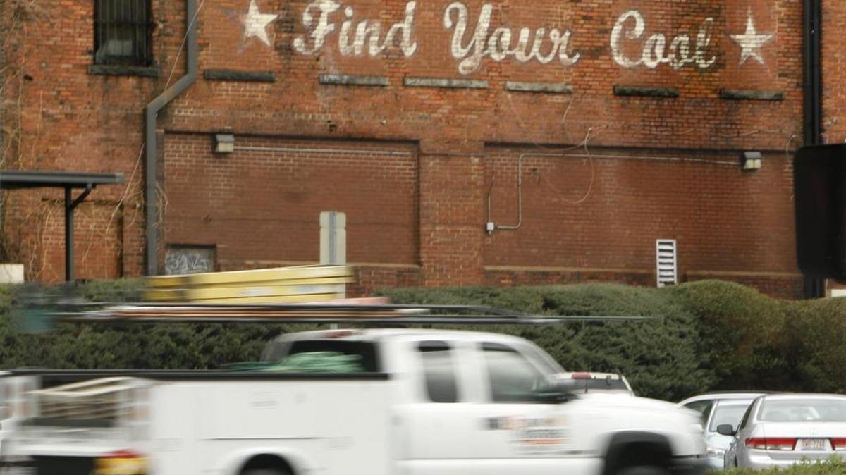 The painted slogan promoting downtown Durham on a brick building seen by passers-by on on Ramseur Street in the downtown Durham, NC loop in 2013. It was the brainchild of the Downtown Durham, Inc. staff, which is supported now by the Business Improvement District tax.
