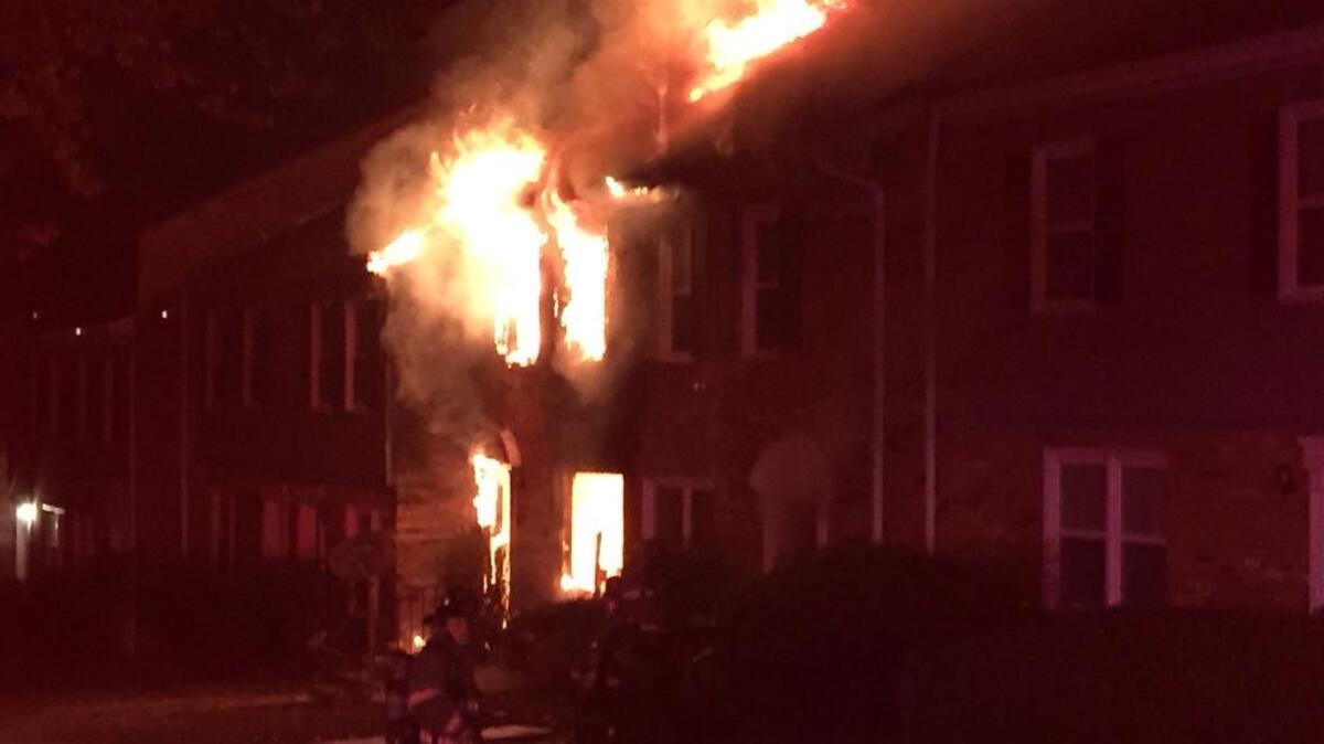 Flames shoot through the windows on both floors of the 200 Seven Oaks Road, Durham, blaze that displaced 13 people before dawn Sunday.