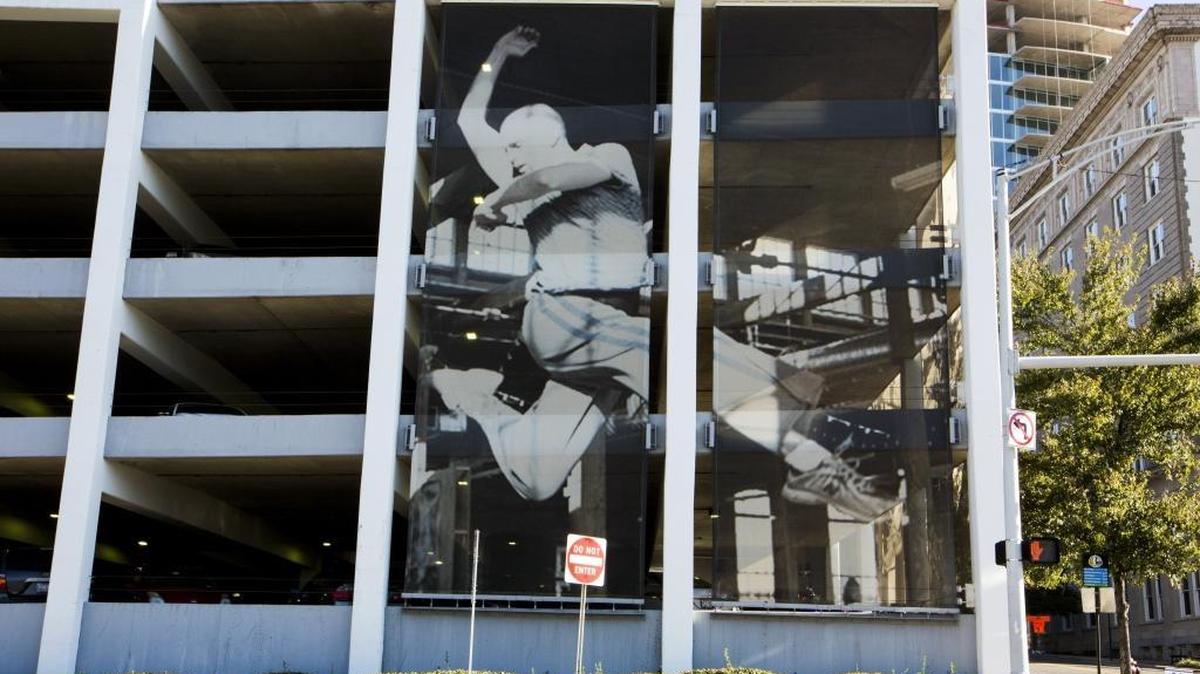 A weathered banner depicting dancer Andrew Lamar can be seen along Pettigrew Street, facing DPAC on Tuesday, Oct. 3, 2017, in Durham, NC.