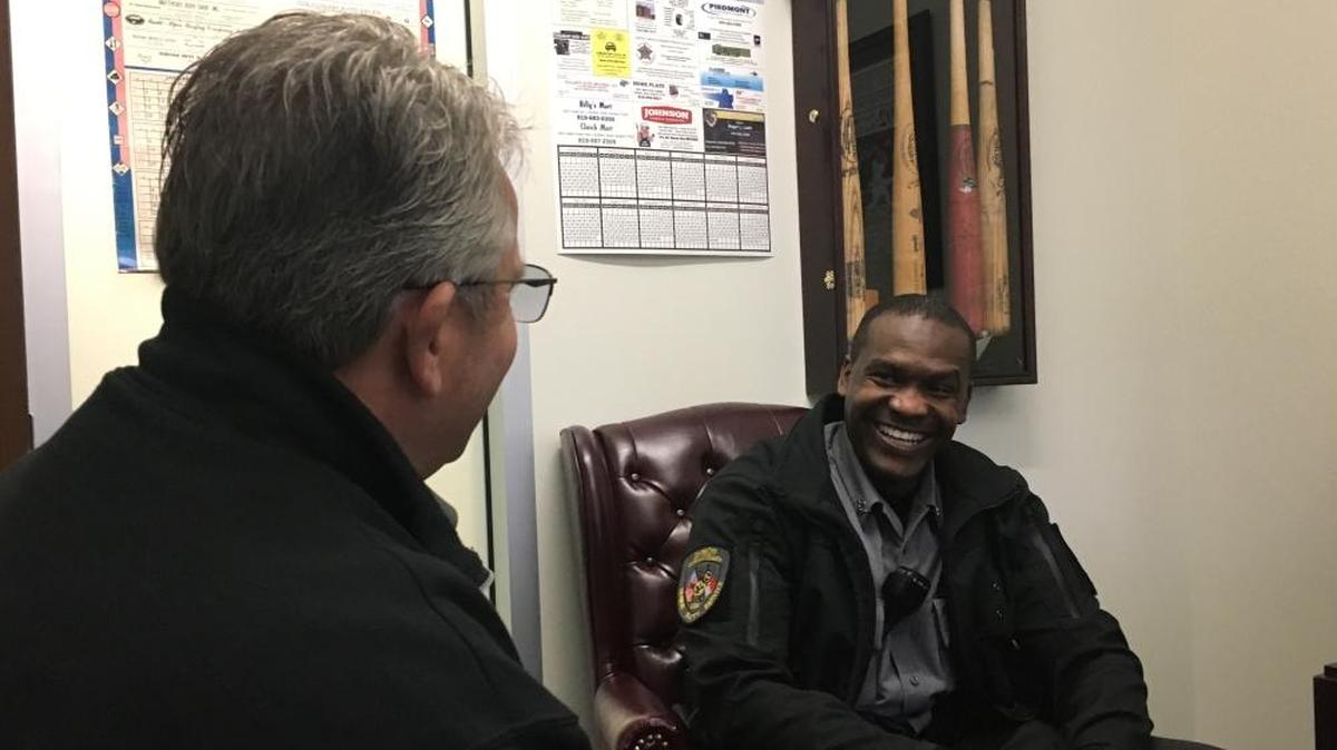 Durham County Sheriff Mike Andrews (left) chats with Deputy Joseph Derilus (right) about serving the community.