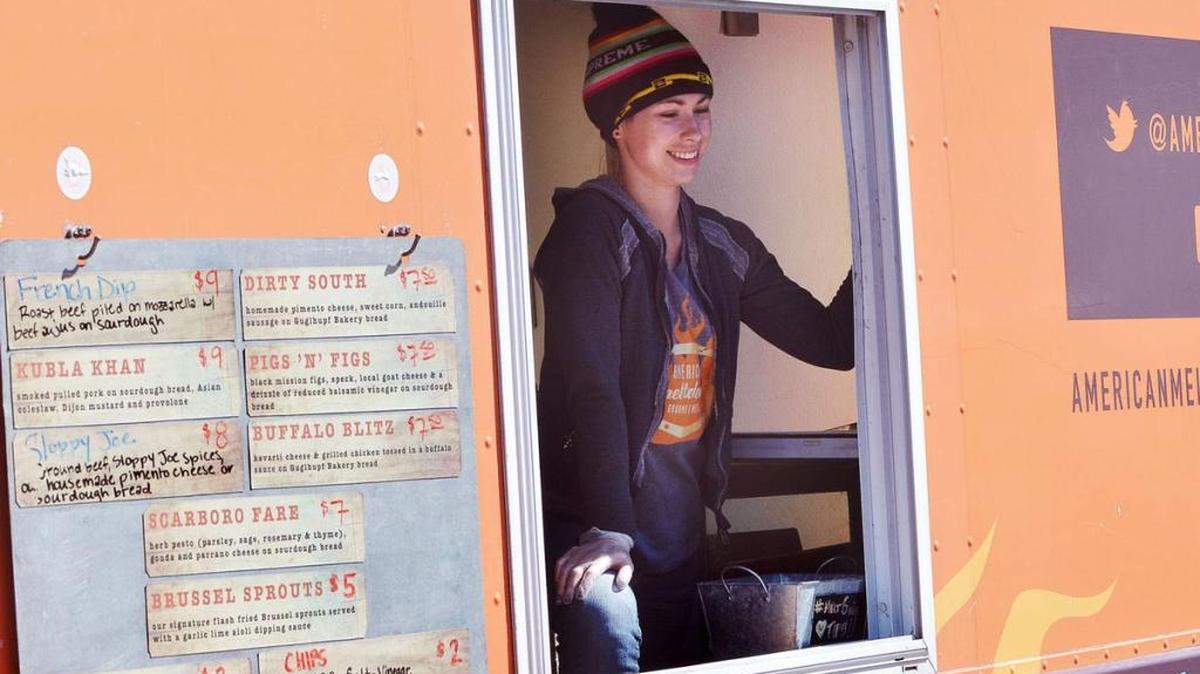 Rebecca Holliman of American Meltdown greets customers Sunday during the Durham Central Park Food Truck Rodeo.