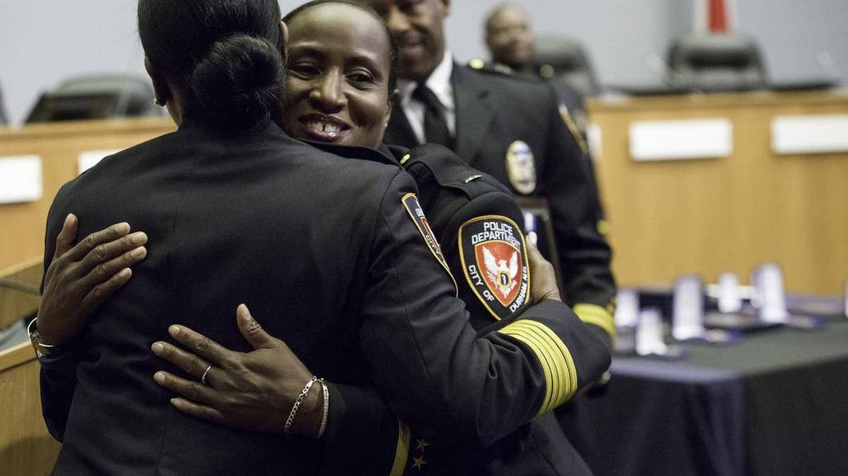 Lt. Denise Campbell is embraced by Chief C.J. Davis after receiving the Chief’s Award Thursday. Captain Daniel Edwards is pictured at rear.