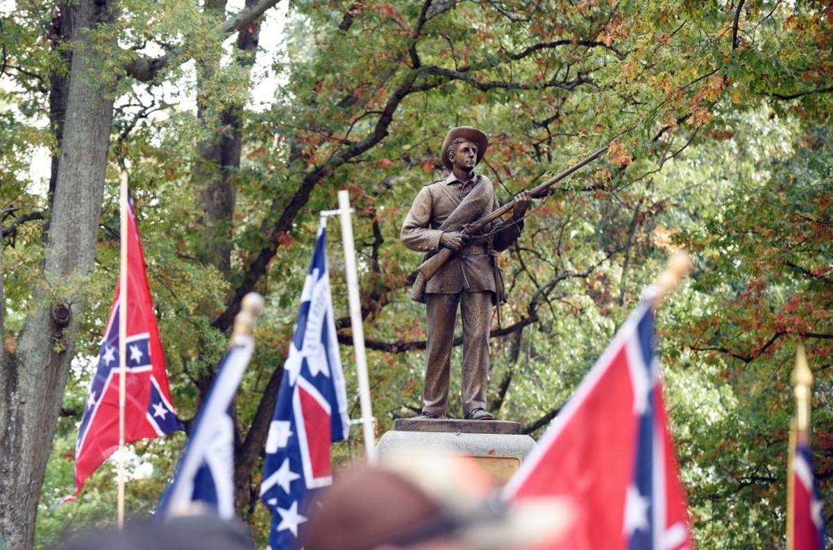 Confederate flags frame ‘Silent Sam’ during a rally on the UNC campus in 2015. The rally, held in support of keeping the monument on campus, was held by Alamance County Taking Back Alamance County.