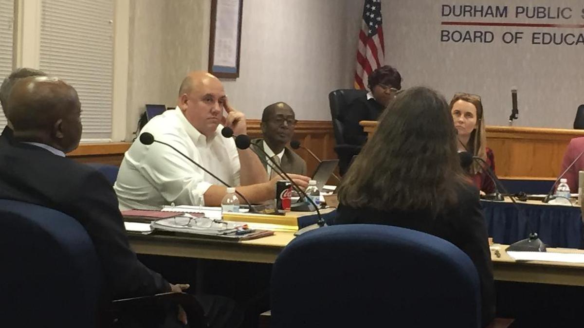Durham Public Schools officials, including Superintendent Pascal Mubenga (left, back to camera), discuss issues with Restart participation with DPS Board of Education members including Matt Sears (center, white shirt) and staff members at a DPS school board work session Thursday.