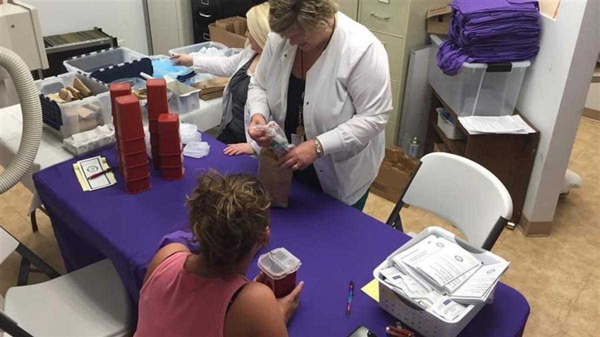 Registered Nurse Carol Simmons prepares a bag of sterile IV injection supplies -- including syringes, alcohol swabs and sterile water as part of a needle exchange program in Huntington, West Virginia. Huntington adopted the program to try to prevent drug overdoses. North Carolina currently has 26 safe syringe programs to prevent opioid abuse and blood-borne diseases.