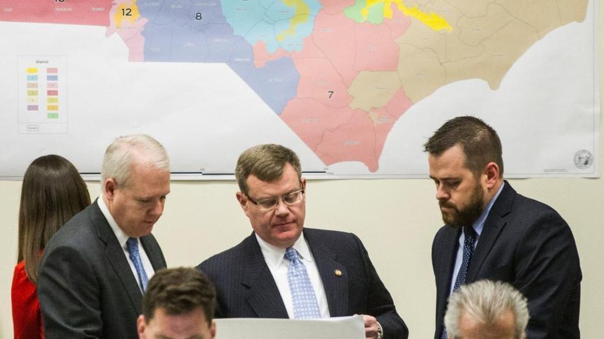 State House Speaker Tim Moore, center, looks over a proposed Congressional redistricting map during a February 2016 committee meeting. A court, leaning among other things on a Duke professor’s analysis, declared the map unconstitutional this week.