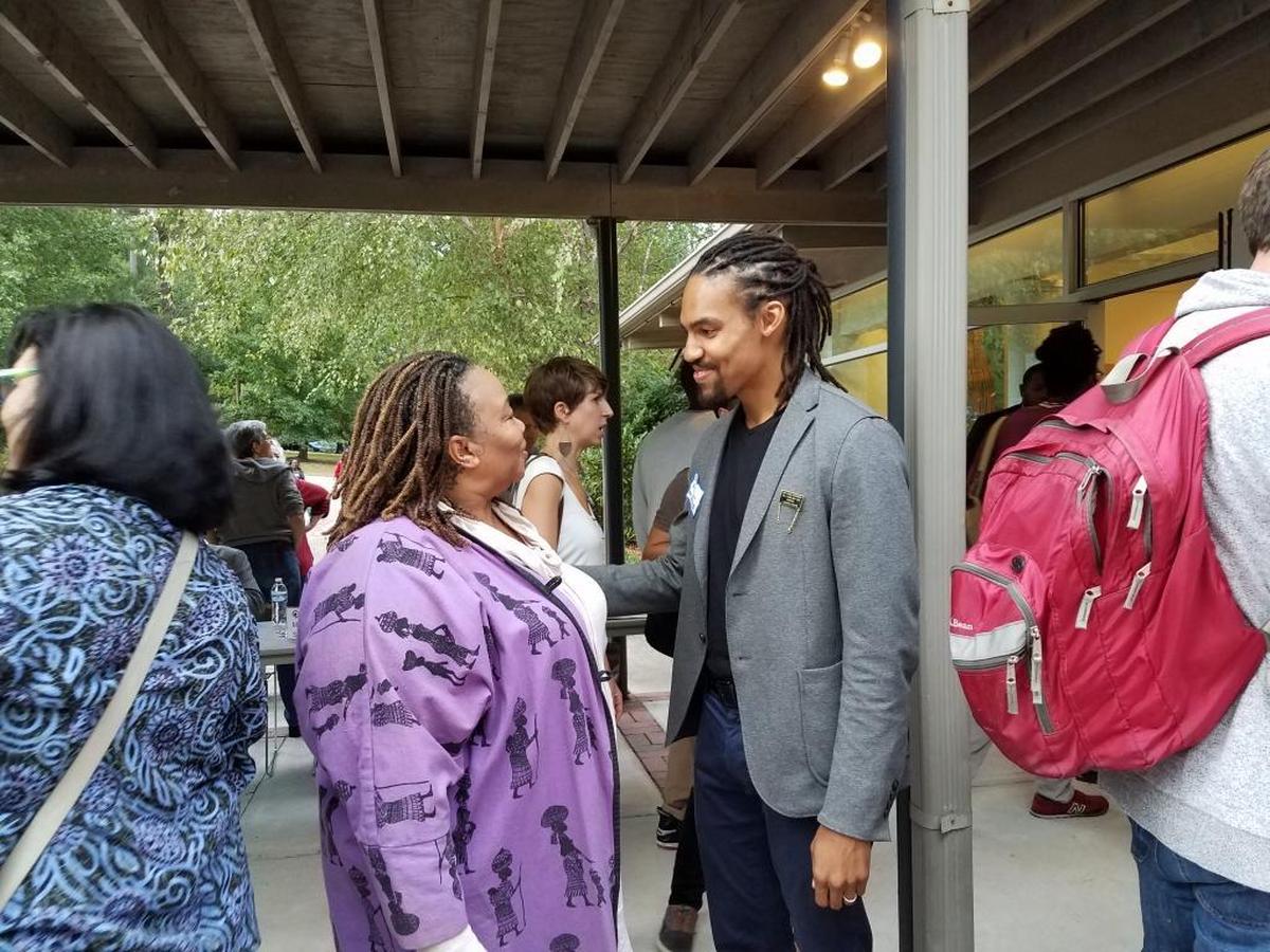 Pierce Freelon, 33, is the youngest mayoral candidate. He’s pictured here greeting people to the People’s Alliance PAC endorsement meeting in August.