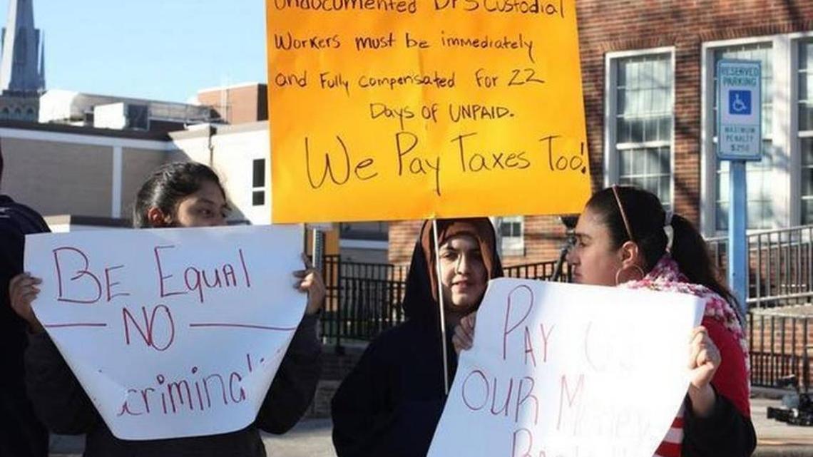 Fired custodians protest outside Durham Public Schools headquarters Friday, Feb. 6, 2015, for wages they were not paid when their employer, a subcontractor, filed for bankruptcy.