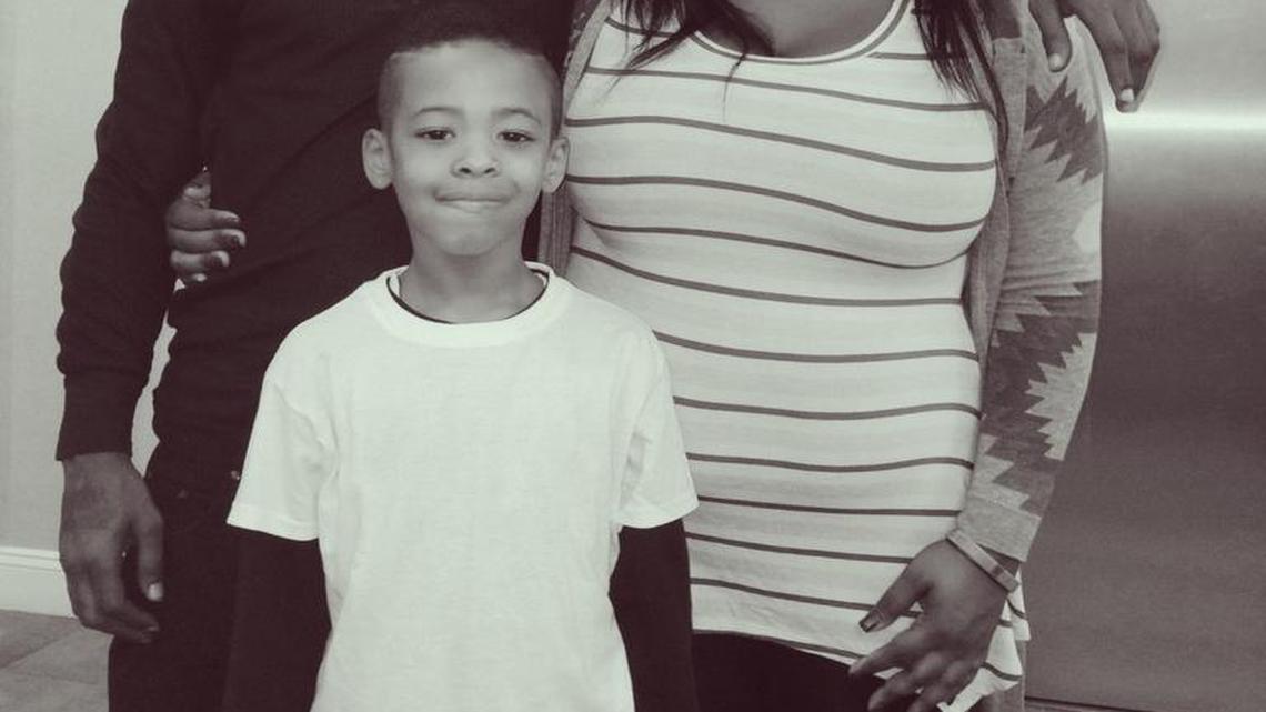 Kamari Munerlyn, middle, with his father Theo Munerlyn and aunt Mika Mitchell in this photograph from 2015.