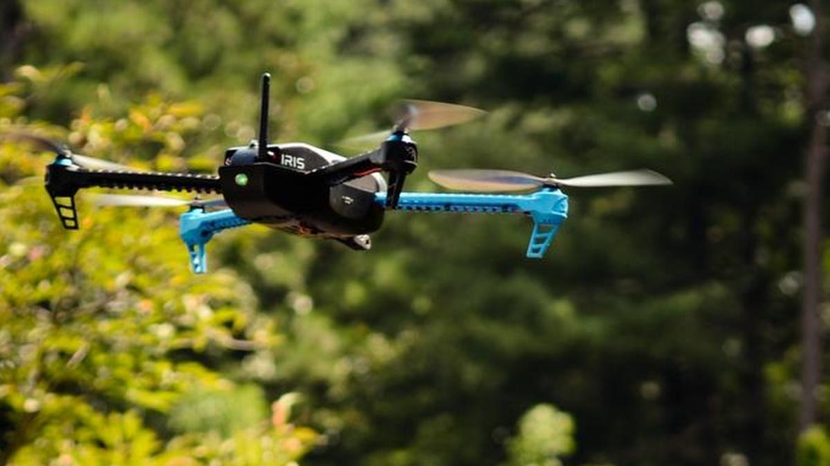 Mary ‘Missy’ Cummings is pictured with a hovering drone in Duke’s Sarah P. Duke Gardens, where she will work to generate a set of inexpensive, unobtrusive best practices to deter unwanted drone usage.