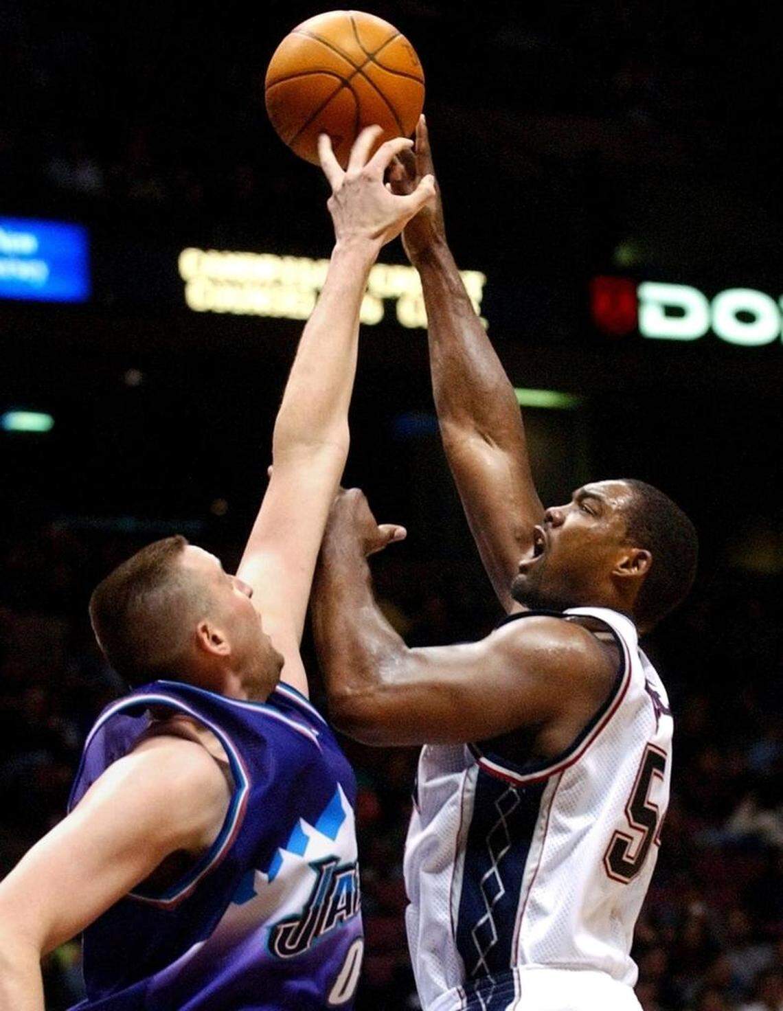 Utah Jazz center Grag Ostertag, left, blocks a shot by New Jersey Nets’ Rodney Rogers during the fourth quarter Sunday, March 2, 2003, in East Rutherford, N.J. The Jazz won 91-90. (AP Photo/Bill Kostroun)